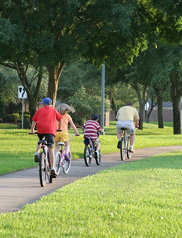 Bike riders on path surrounded by Tall Fescue grass